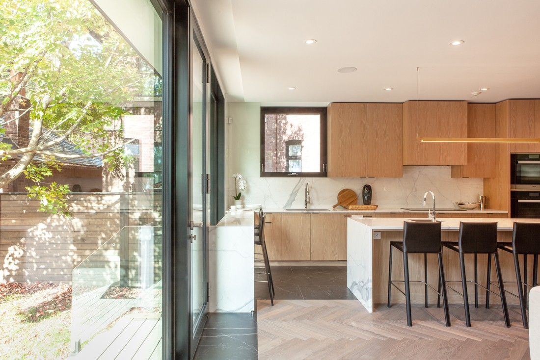 Luxury kitchen in Rosedale, Toronto custom home with natural light from floor-to-ceiling windows