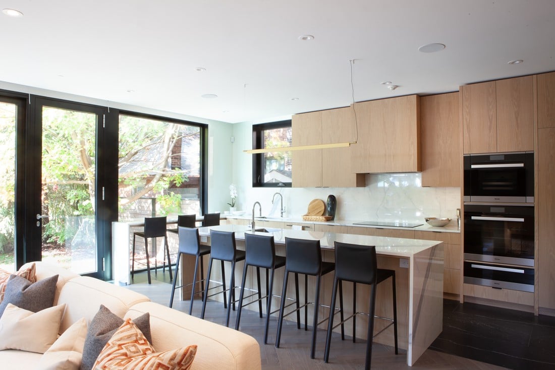 Luxury kitchen in Rosedale, Toronto custom home with wood flat panel cabinets and island with seating