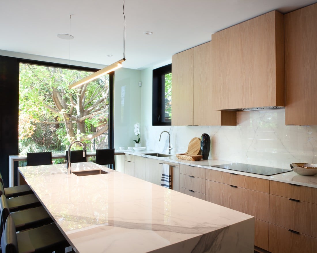 Luxury stone backsplash in Rosedale, Toronto kitchen with modern bar light over island