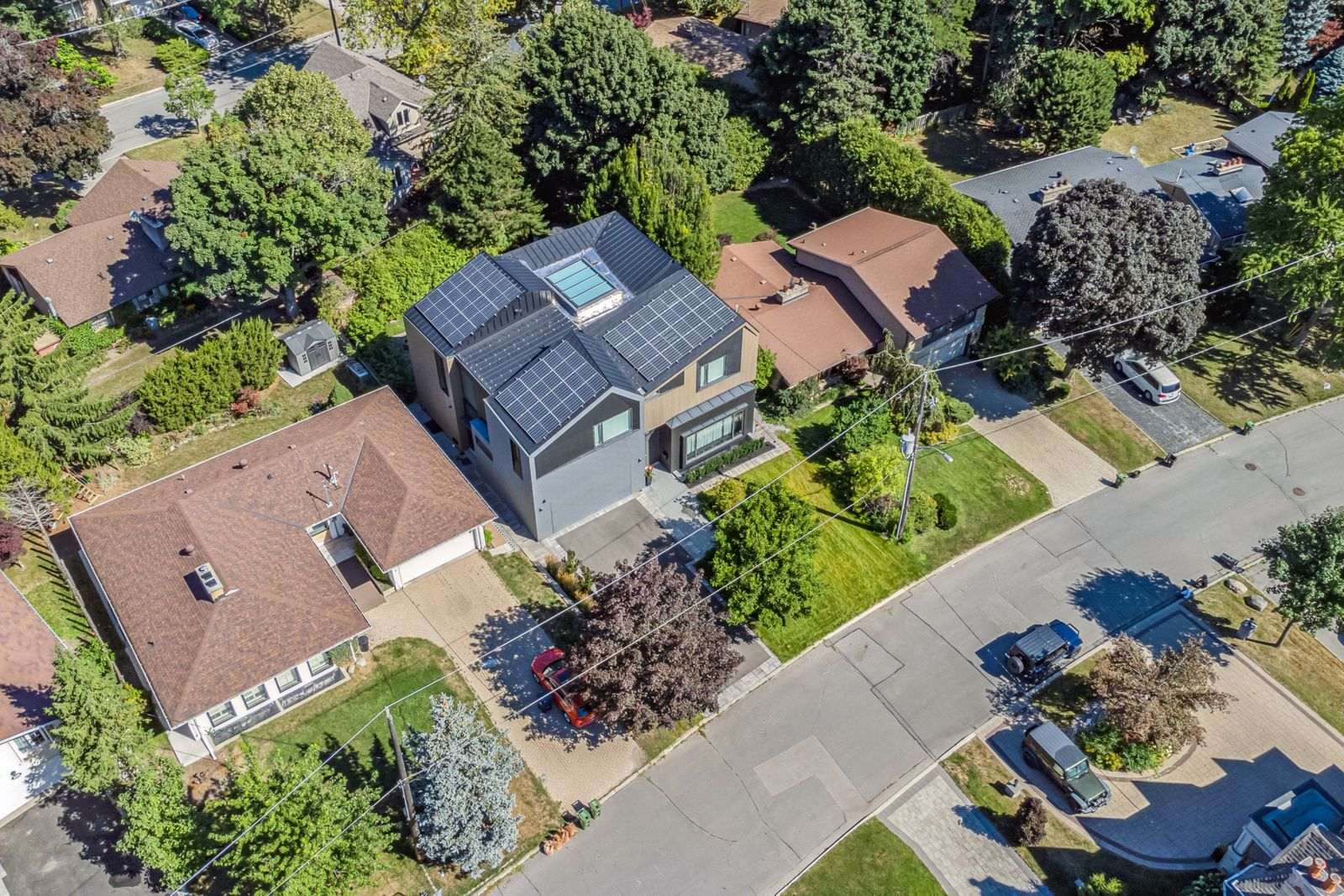 Aerial rooftop modern zinc cladding with solar panels and skylight in home renovation in Toronto