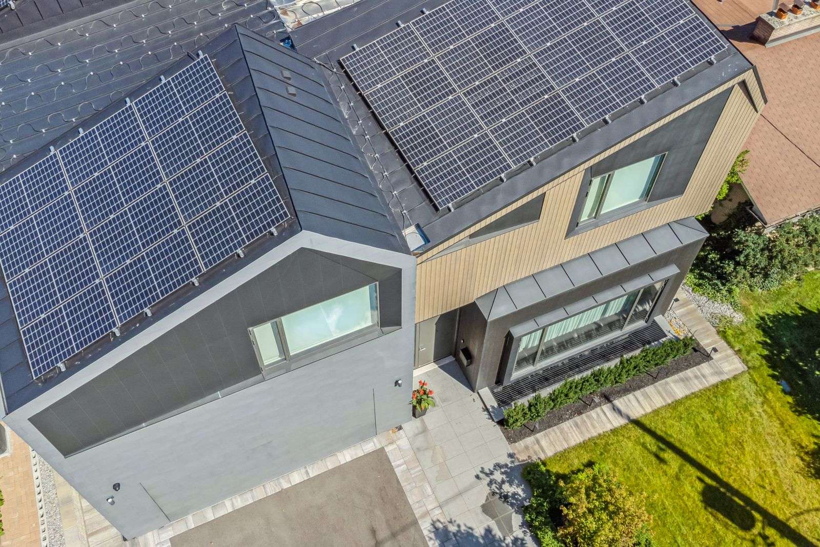 Aerial rooftop of custom home with modern zinc cladding and solar panels in Toronto