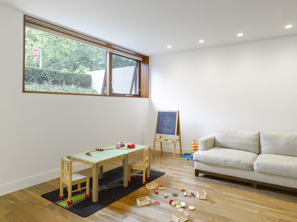 Children's play area in walkout basement in Toronto custom home by SevernWoods