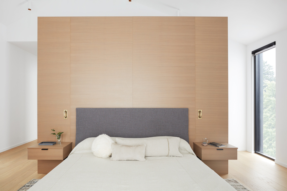 Custom wood cabinet design behind bed in minimalist style custom home in Toronto by SevernWoods