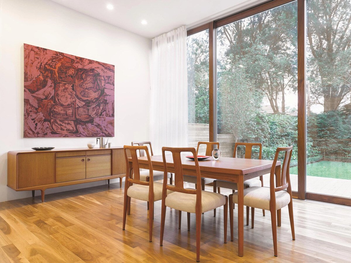 Dining room with Bauhaus windows in Toronto custom home by SevernWoods