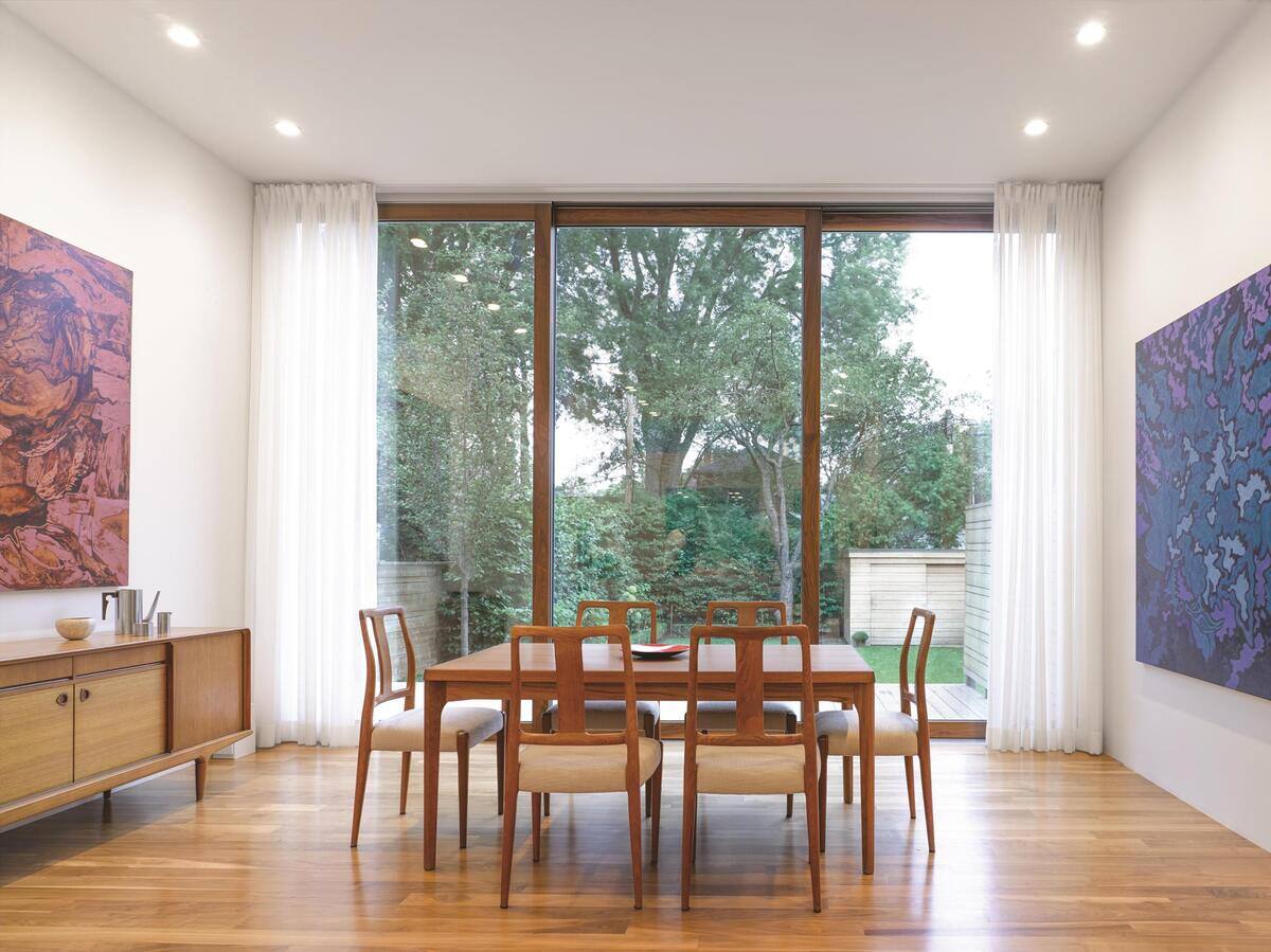 Floor-to-ceiling Bauhaus windows in dining room of Toronto custom home by SevernWoods