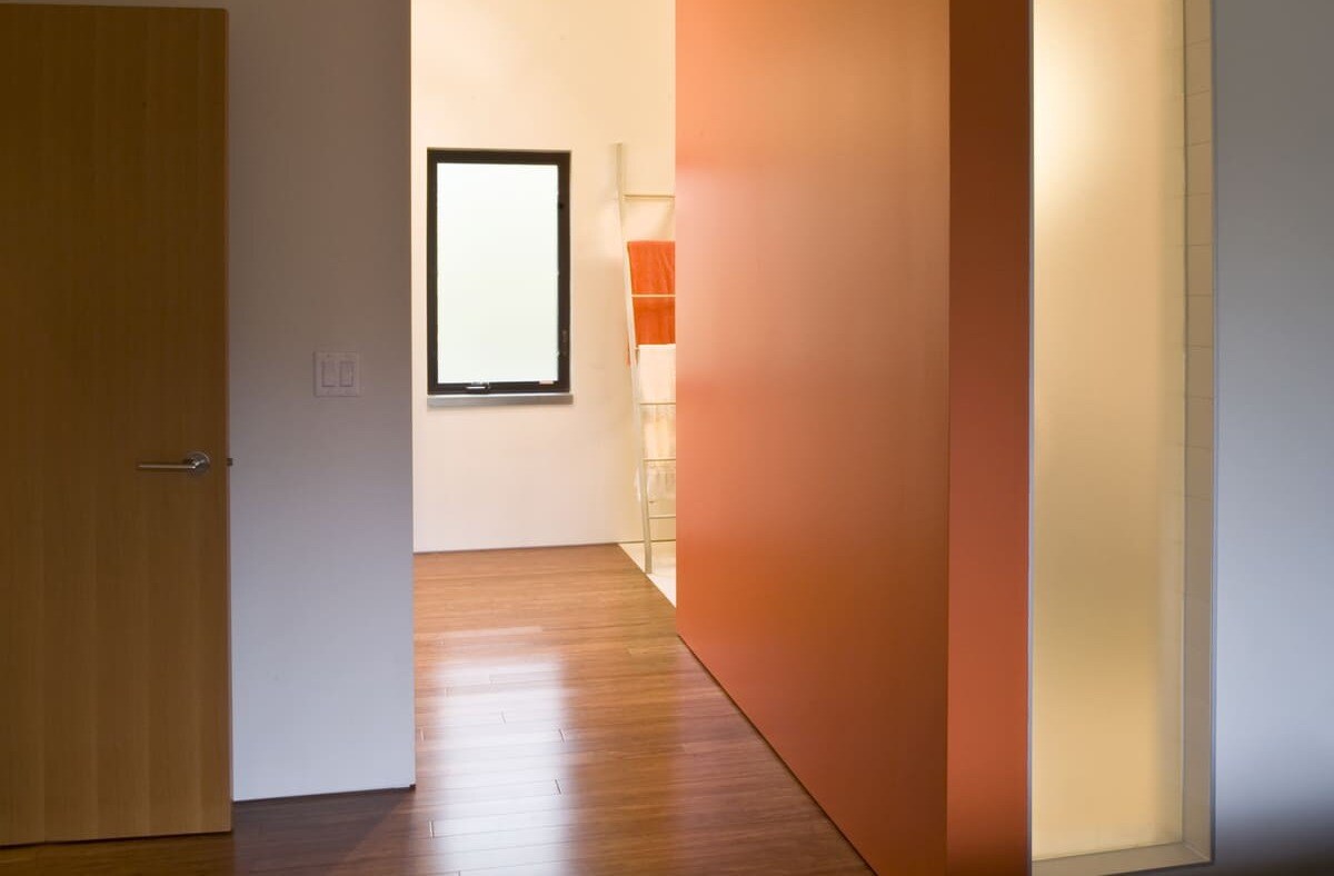 Interior of luxury home renovation in North York with in-floor heating system and orange accent wall