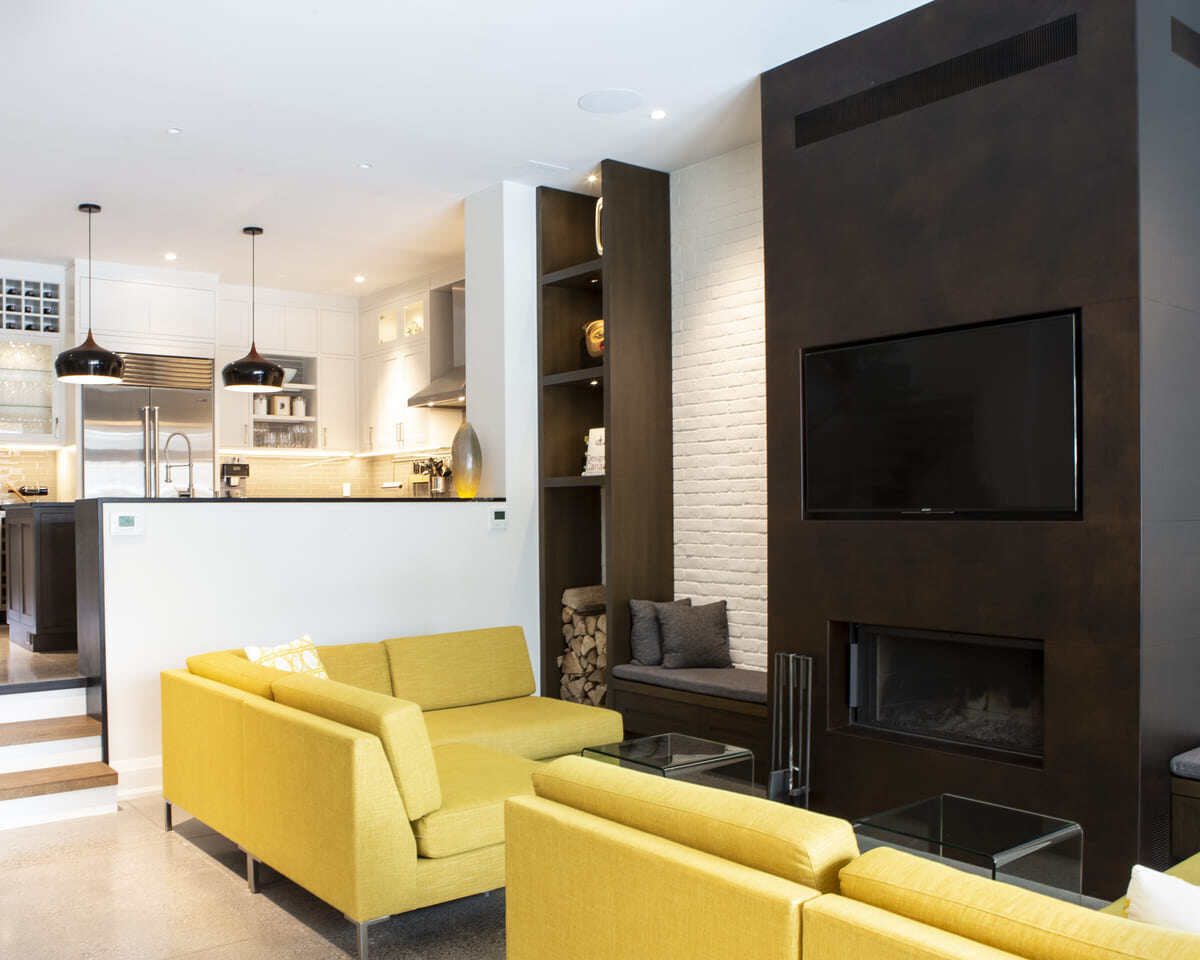 Wood burning fireplace in living room below mounted TV in Toronto home renovation by SevernWoods