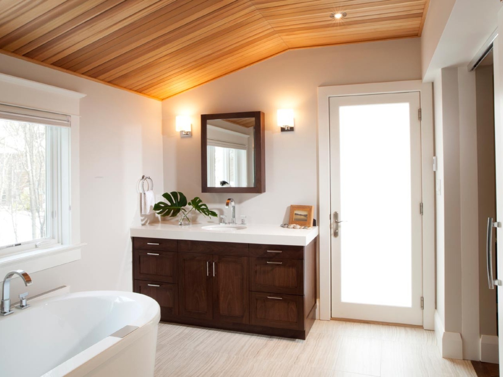 Wood ceiling with freestanding tub and bathroom vanity in Toronto luxury home