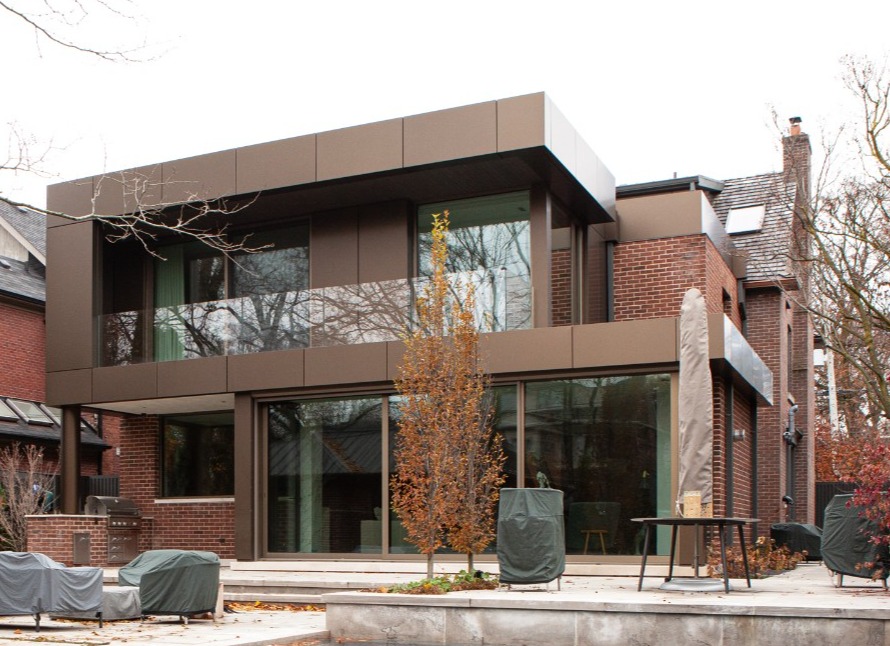 Backyard shot of addition and renovation in Toronto with pool by SevernWoods