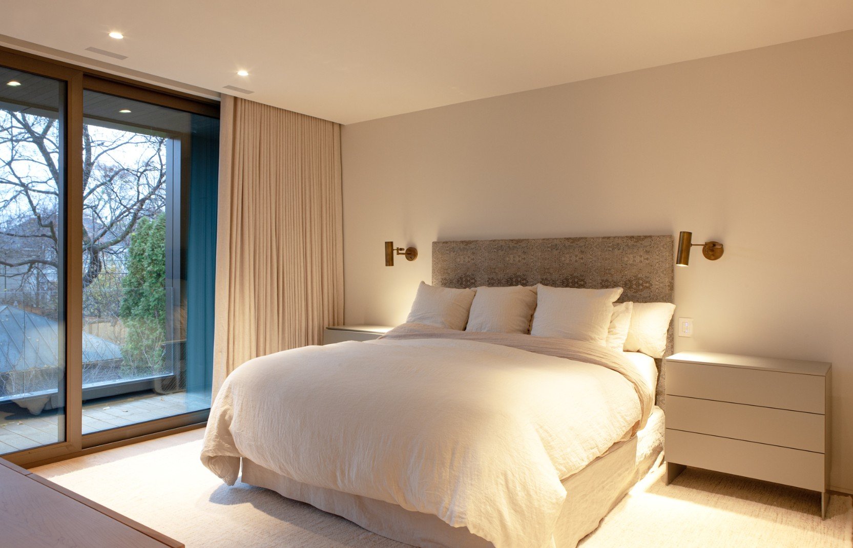 Primary suite with floor-to-ceiling windows and recessed drapes in Toronto renovation and addition by SevernWoods