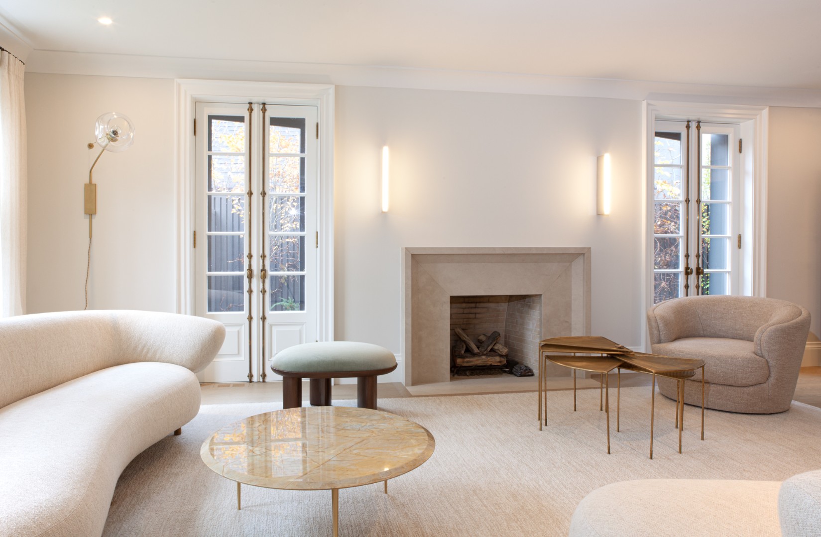 Two white French doors with stone fireplace in between in Toronto renovation and addition by SevernWoods