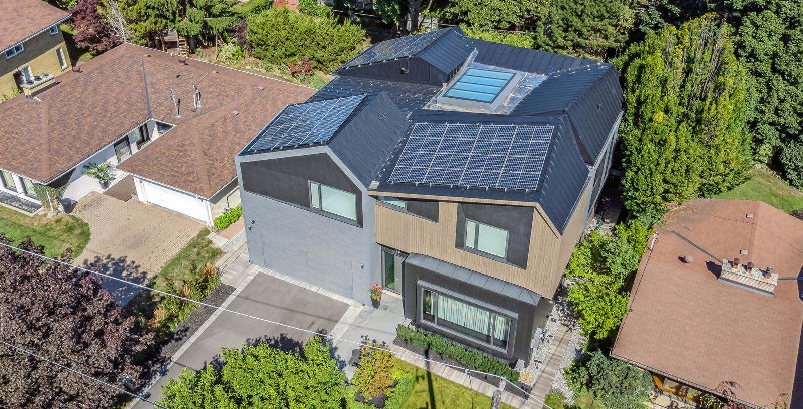 aerial rooftop modern zinc cladding with solar panels and skylight in home renovation in toronto5